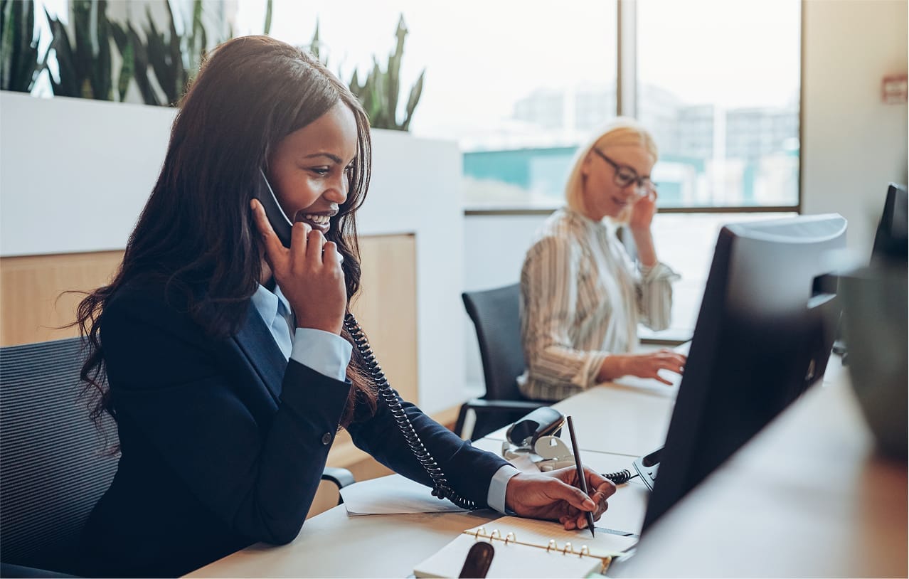 American businesswoman smiling and talking on a telephone